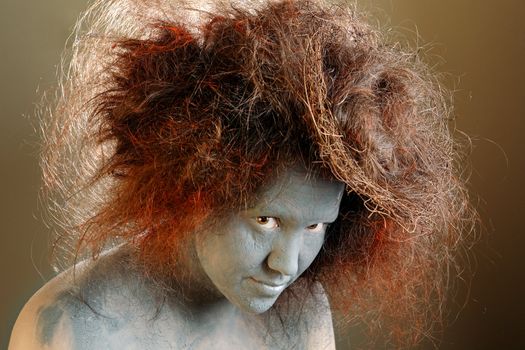 Woman with a painted face and a nest in hair