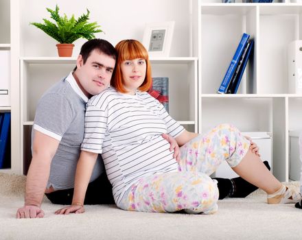 portrait of a pregnant woman and man, at home