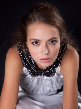 Romantic young caucasian woman on black background