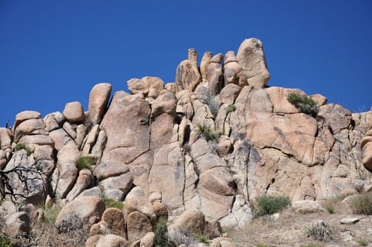 Rocks and boulders appear to be stacked together near the desert town of Joshua Tree, California.