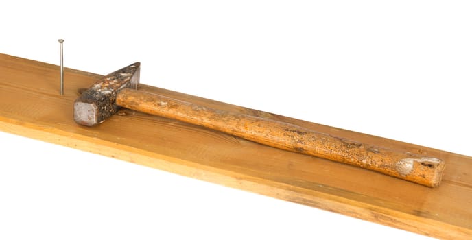 Hammer, nail and wooden board, isolated on background