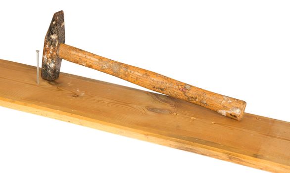 Hammer, nail and wooden board, isolated on background