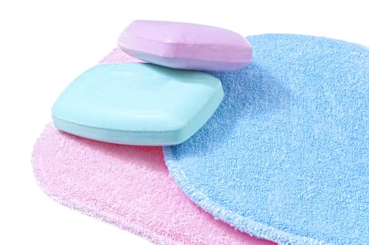 bath sponges in three different colors on white background