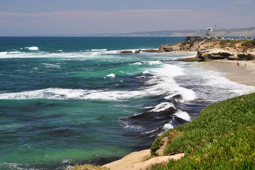 Waves roll in toward shore at a scenic beach in La Jolla, California near San Diego.