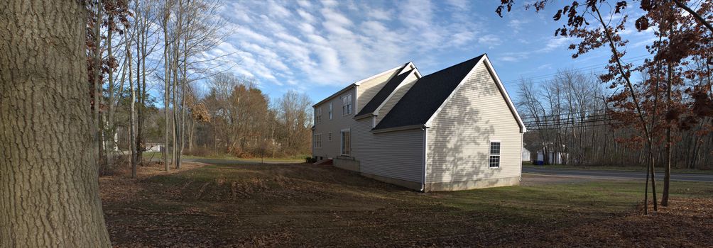 Modern custom built residential home newly constructed with a 2 car garage in a residential neighborhood.  