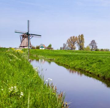 Panorama of the traditional Dutch windmill near the channel. Netherlands