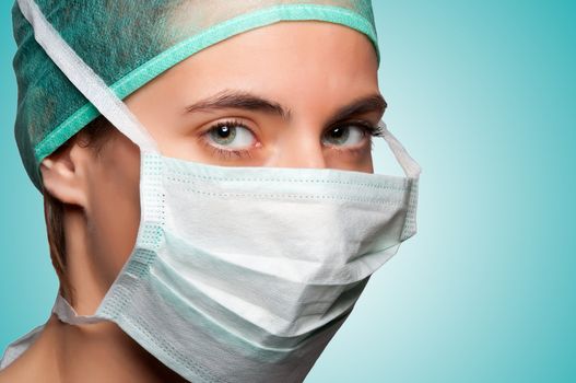 Closeup portrait of a female surgeon in a green background