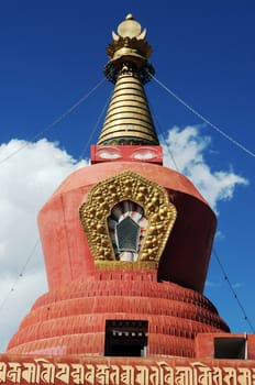 A historic Tibetan buddhist red stupa against blue sky