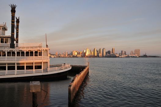 An old paddle wheel boat frames this distant view of the San Diego, California skyline.