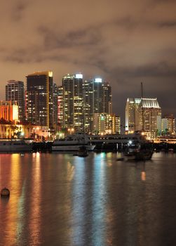 The lights of downtown San Diego, California reflect in the water of the harbor.