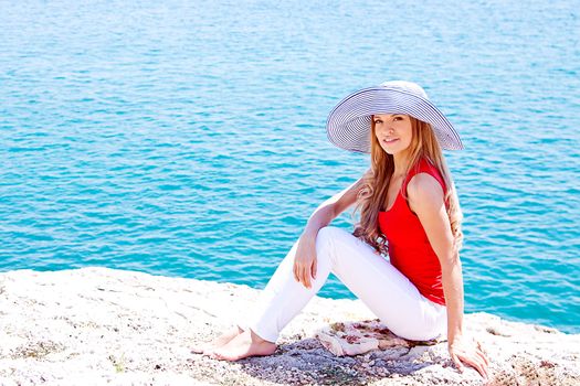 portrait of a beautiful young girl who rests on the coast