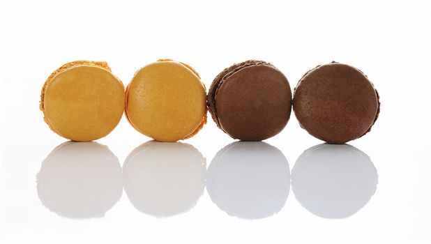 chocolate and caramel macaroons isolation on a white background 