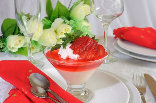 Dessert of yogurt with strawberry jelly with whipped cream and strawberries