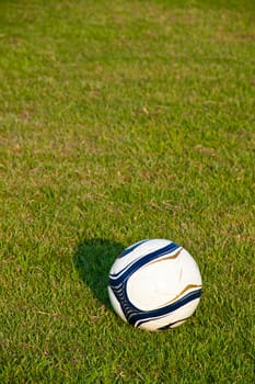 Soccer ball or football ball on green field