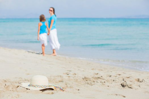Photo of straw beach hat on exotic white sand beach