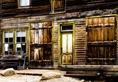 Wooden storefront of an old mining ghost town that is weathered.