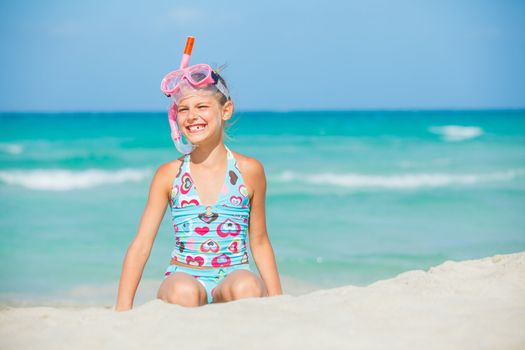 Portrait of a cute girl wearing a mask for diving background of the sea