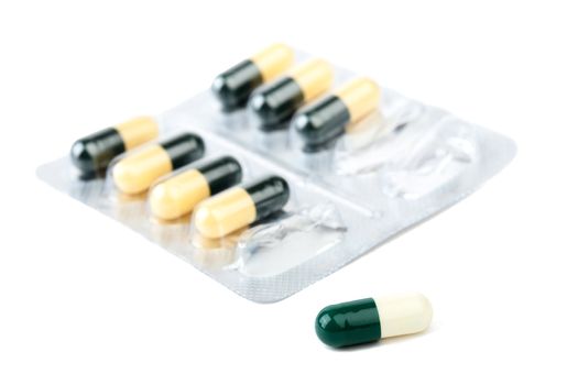  capsule with medicines in blister macro on a white background