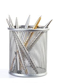 Metal ball-point pens in a support on white background