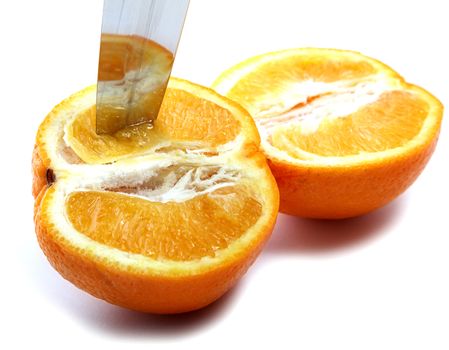 Knife and orange cut half-and-half on a white background