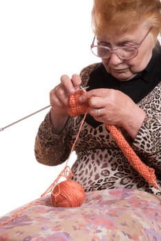 The old woman is engaged in knitting on a white background