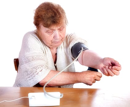 The old woman measures arterial pressure upon a white background