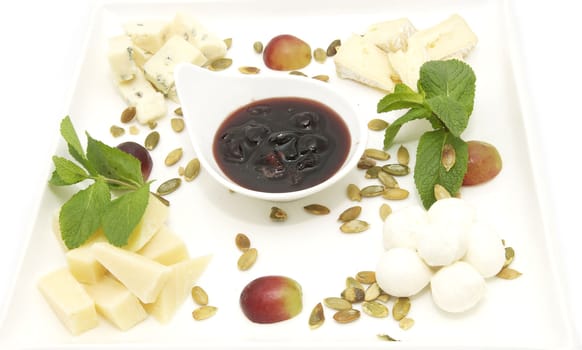 cheese plate with several kinds of cheese on a white background