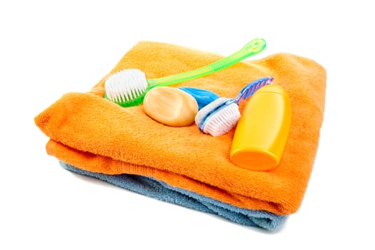 Washed shampoo bath towel and brushes on a white background