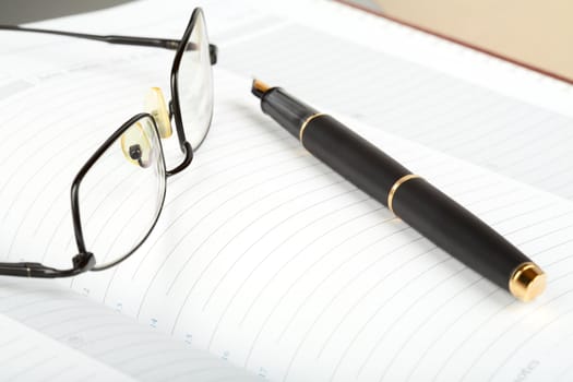 Business a still-life with fountain pen and glasses close-up