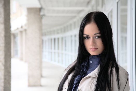 The girl close up against a building wall