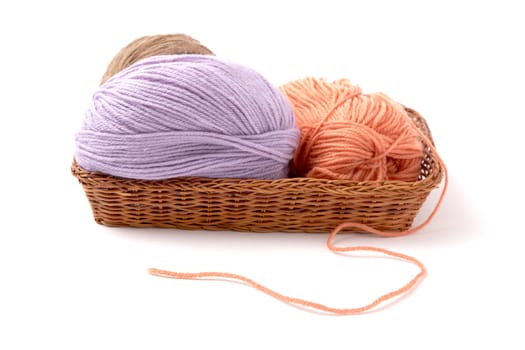 Balls of a yarn knitting in wooden box on white background