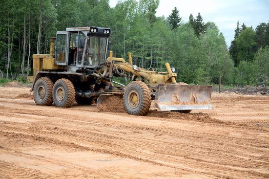 The grader clears away a ground