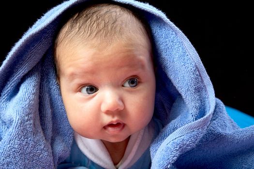 The baby close up on a black background