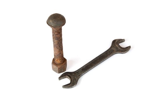 Wrench and rusty bolt with nut on a white background
