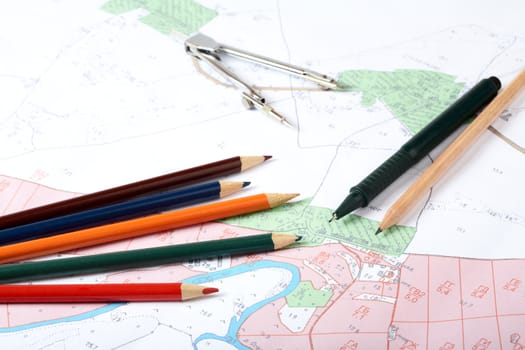 Topographic map of district with a measuring instrument and pencils