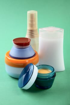 Tubes with  cosmetic cream on a green background