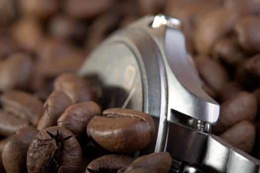 Watch in a heap coffee grains macro