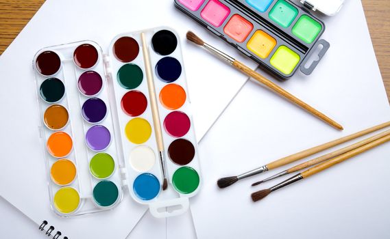 Water colour paints  brush albums for drawing on a table