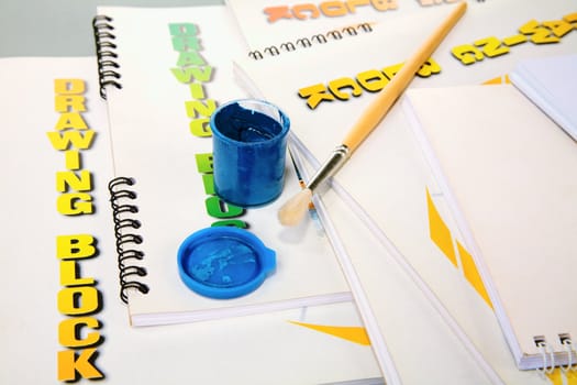 Albums for drawing and a paint on  grey background