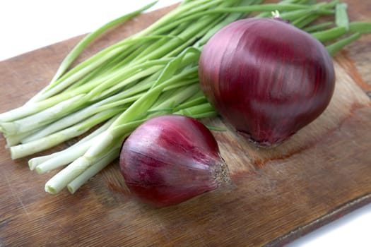 bulb and green onion a chopping board