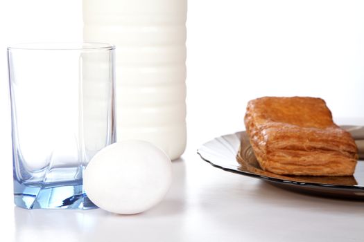 Milk an egg and  roll in a plate on table