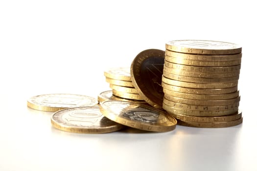 Pile of yellow metal coins on a textural background