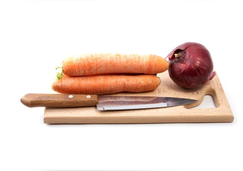 Carrots an onions and  knife on a chopping board  white background