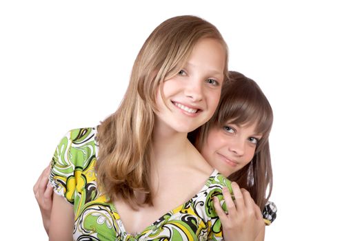 Two smiling girls isolated on a white background