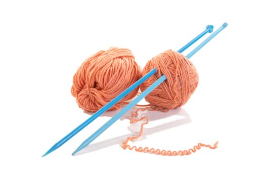 Knitting spokes with ball of wool on white background