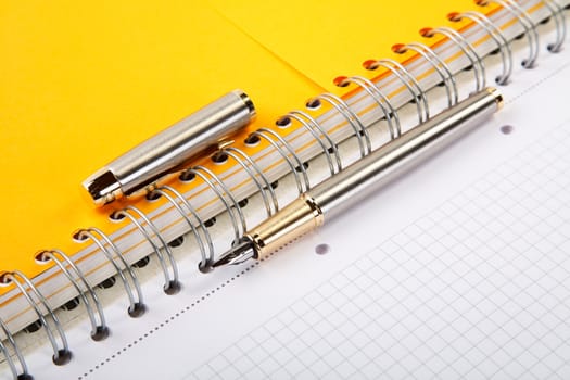 fountain pen and  writing-book on a spiral close up