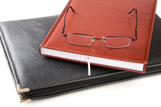 Folder for papers an organizer and glasses isolated on a white background