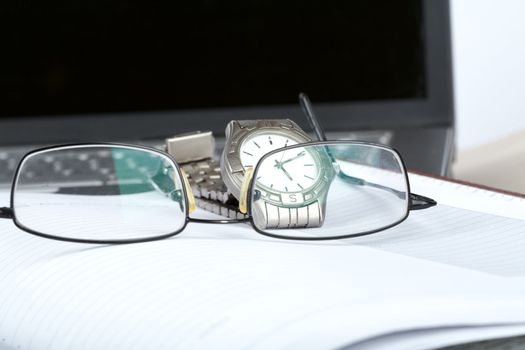 Organizer glasses and notebook on a desk