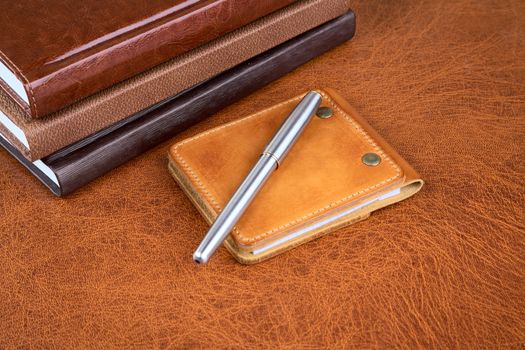 Business  still-life with leather organizers and a pen