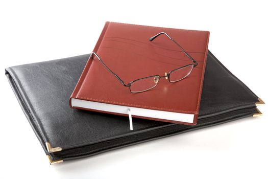 Folder for papers an organizer and glasses on a white background